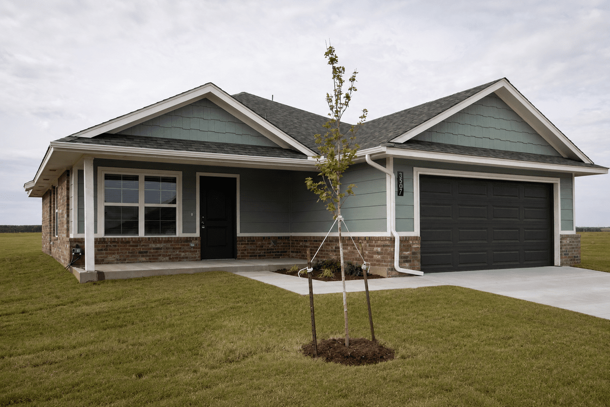 Brand-new single-family home at Enclave Estates: sage-green siding with brick, covered front porch, and 2-car garage